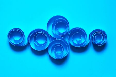 Abstract composition made from paper spirals on blue backgroundの写真素材