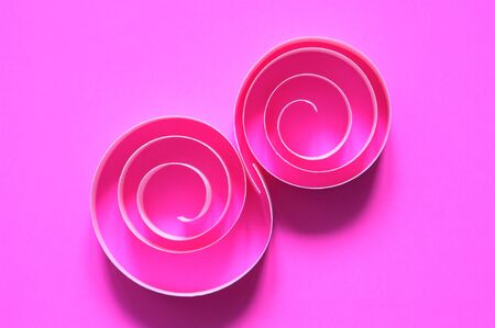 Abstract composition made from paper spirals on pink backgroundの写真素材