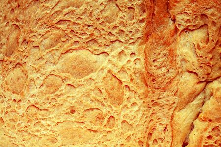 Extreme closeup of loaf of wheat bread as backgroundの写真素材