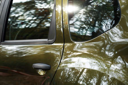 Nice background. Side of the car with reflection of treesの写真素材
