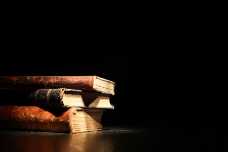 Stack of old books on dark backgroundの写真素材