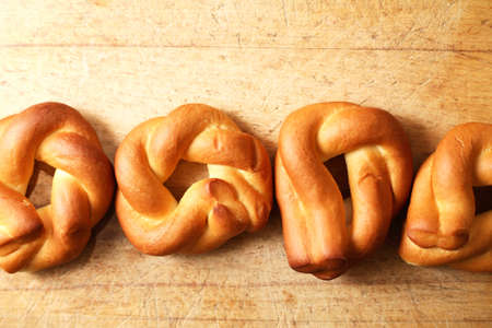 Few freshness bagels on old wooden background with free spaceの写真素材