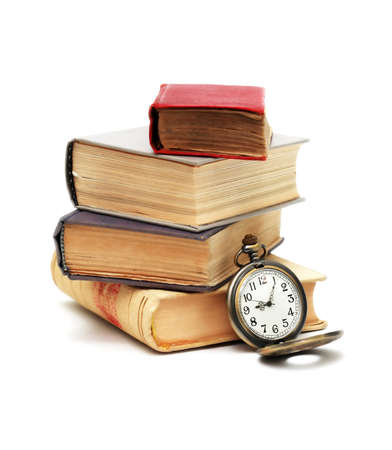 education concept. Stack of books near pocket watch on white backgroundの写真素材