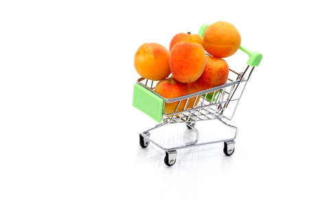 healthy eating concept. Shopping cart with freshness apricotsの写真素材