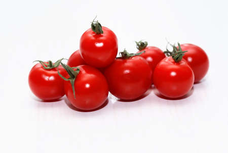 Heap of nice freshness red tomatoes on white tableの写真素材