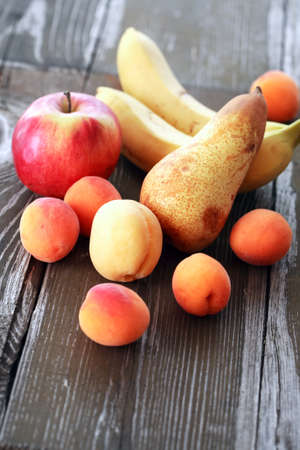 Heap of various freshness fruits on nice old wooden tableの写真素材