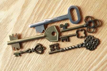 Set of various old keys on wooden surfaceの写真素材