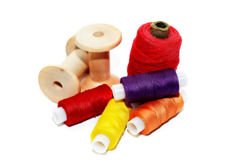 A set of multicolored threads on a white backgroundの写真素材