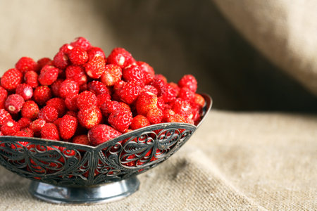 Lot of freshness red wild strawberries in nice vintage bowlの写真素材