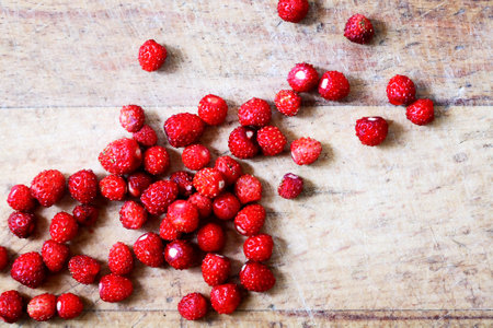 Lot of freshness red wild strawberries on old wooden backgroundの写真素材