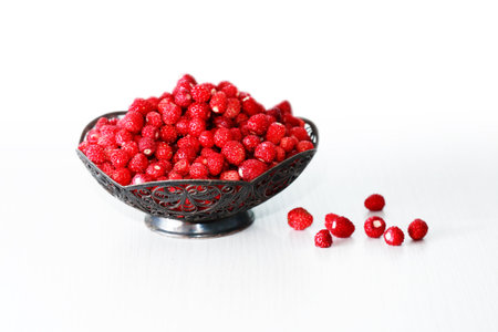 Lot of freshness red wild strawberries in nice vintage bowlの写真素材