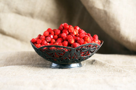 Lot of freshness red wild strawberries in nice vintage bowlの写真素材