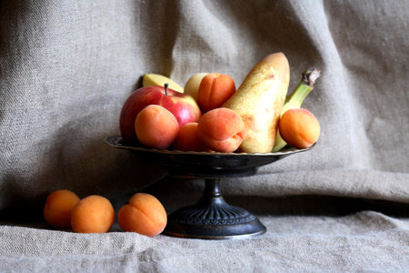 Heap of freshness fruits in bowl againast nice gray canvas backgroundの写真素材