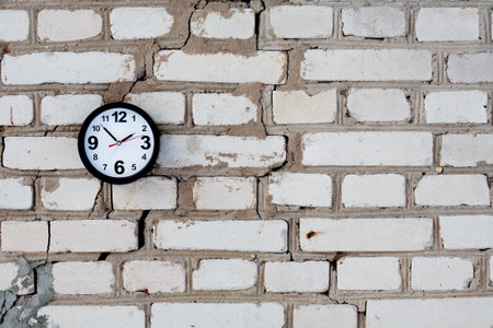 Clocks on a brick wall with free spaceの写真素材