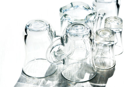 A set of clean dishes with long shadow on white background under sunlightの写真素材