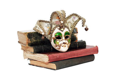 Nice old Venetian mask near books isolated on white backgroundの写真素材