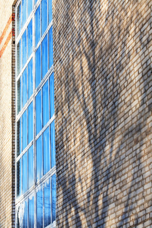 Large window on the facade of an industrial buildingの写真素材