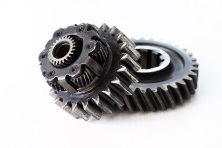 Part of the mechanism. Few old black gears on white backgroundの写真素材