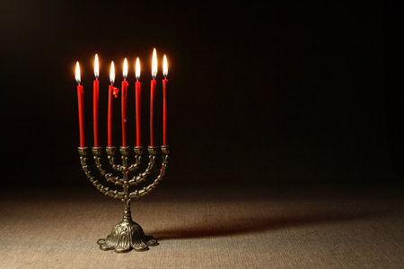 Traditional jewish menorah with lighting candles on nice dark backgroundの写真素材