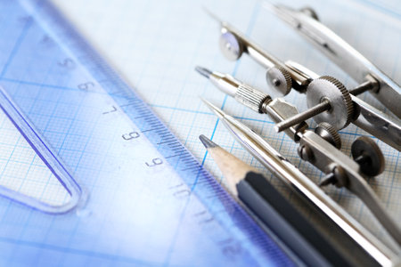 Set of old drawing tools on background with graph paper