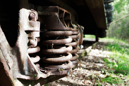 An abandoned old railway in the middle of the forest with rusty train