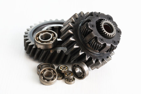 Part of the mechanism. Few old black gears on white background