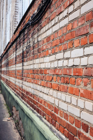 An old wall made of red and white bricksの写真素材