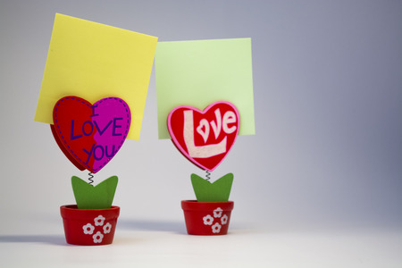 White background. Wooden hearts with clothespegs for stickers on a spring. Congratulation. Invitation. St. Valentine's Day. A decor for the house. Blank space of day of an inscription.の写真素材