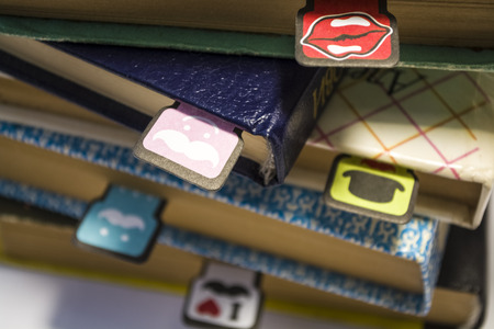 Old books on a white background. Cheerful and amusing bookmarks with moustaches of different coloring.の写真素材