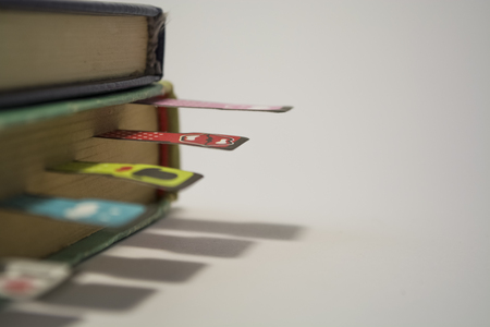 Old books on a white background. Cheerful and amusing bookmarks with moustaches of different coloring.の写真素材