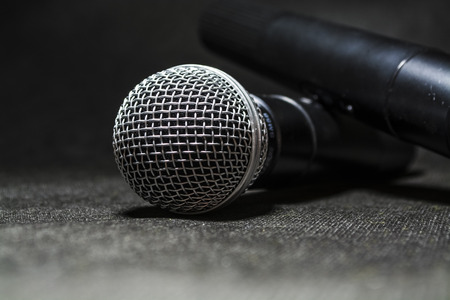 The electric microphone on a monophonic black background. Equipment for the singer or blogger. Music.の写真素材
