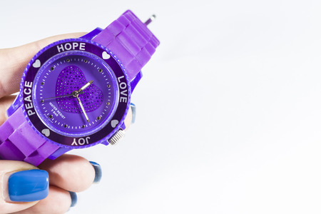White monophonic background. The violet electronic clock on a hand. Love. A blank space for an inscription.の写真素材