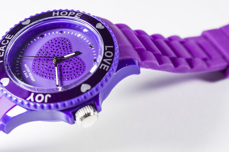 White monophonic background. The violet electronic clock on a hand. Love. A blank space for an inscription.の写真素材