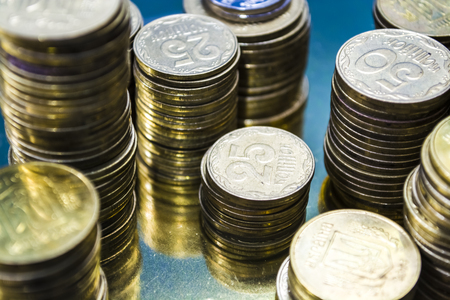 Towers from gold coins. Currency. Business and finance. Profit. Ukrainian hryvnia. Banking....
