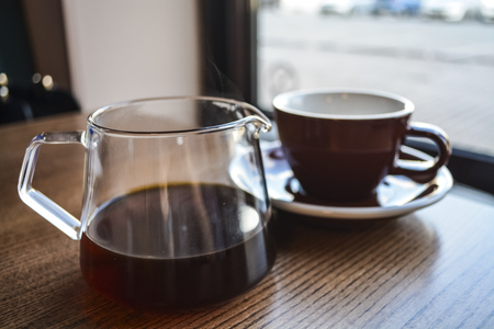 Alternative way of preparation of coffee. The invigorating morning strong drink in the server and a cup.の写真素材