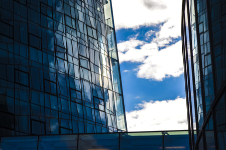 Modern architecture of office buildings. A skyscraper from glass and metal. Reflections in windows...
