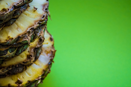 Tropical citrus fruit the pineapple cut on rings on a green background. Healthy food.の写真素材