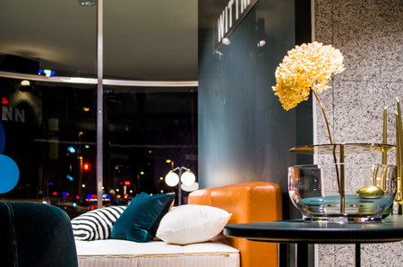 Beautiful flowers in an unusual glass vase in an interior of apartments. A decor for the house and...