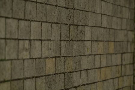 Background or texture from a broken and equal tile with patches of light and drops. Stone blocks on the sidewalkの写真素材
