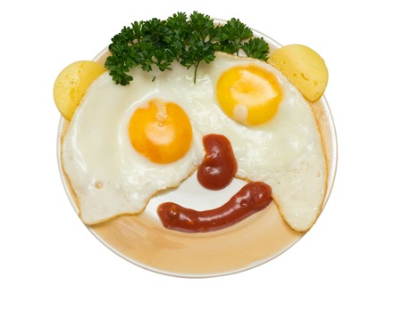 funny faces from eggs with cheese and sauce isolated on white backgroundの写真素材