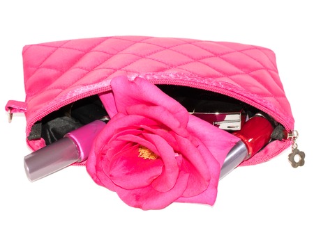 set of cosmetics in pink bag with flower roses isolated on a white backgroundの写真素材