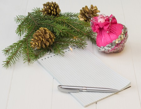 spruce branches with golden cones on a white wooden table. meeting of Christmas and New Year.の写真素材