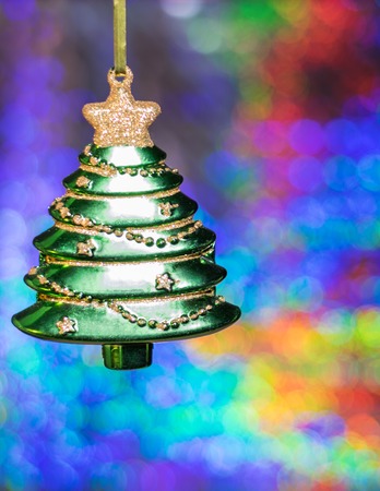 Toy Christmas tree on the background of colorful bokeh. Meeting Christmas and New Year.の写真素材