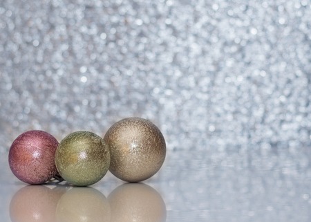 Three different colored Christmas ball on the background bokeh. Shallow depth of field. Christmas...