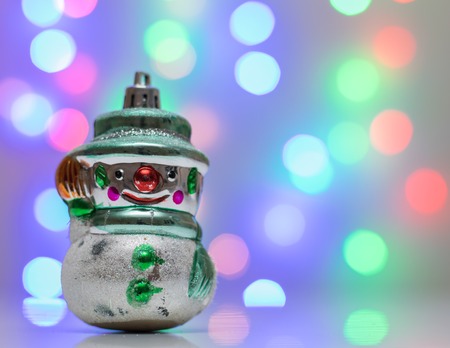 Retro Christmas toy snowman in the background bokeh. Christmas card. New year card.の写真素材