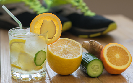 Cold water with lemon, ginger, orange and cucumber. Fitness Accessories. Healthy lifestyle concept.の写真素材