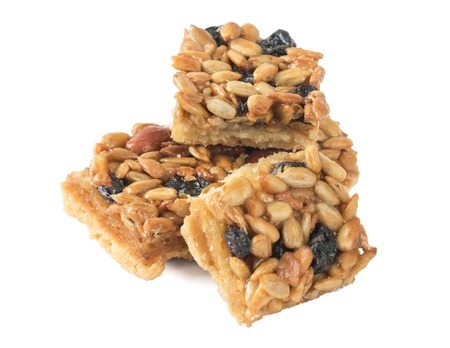 Cookies with peanuts, sunflower seeds and dried grapes. Isolated on white background. A nutritious breakfast.の写真素材