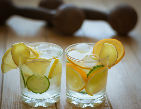 Cold water with lemon, ginger and cucumber. A refreshing drink for sports. Healthy lifestyle concept.の写真素材