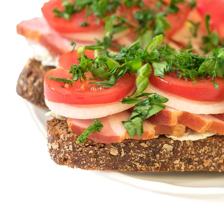 Freshly prepared buterbod ham on the plate isolated on white background. The concept of fast food in the home.の写真素材
