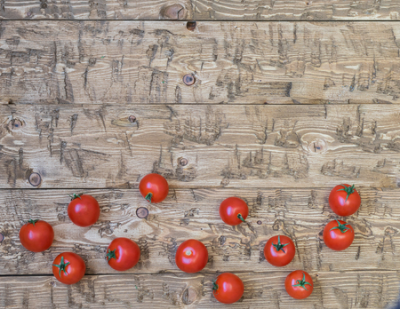 Fresh cherry tomatoes scattered on a rustic table. The concept of healthy homemade food.の写真素材